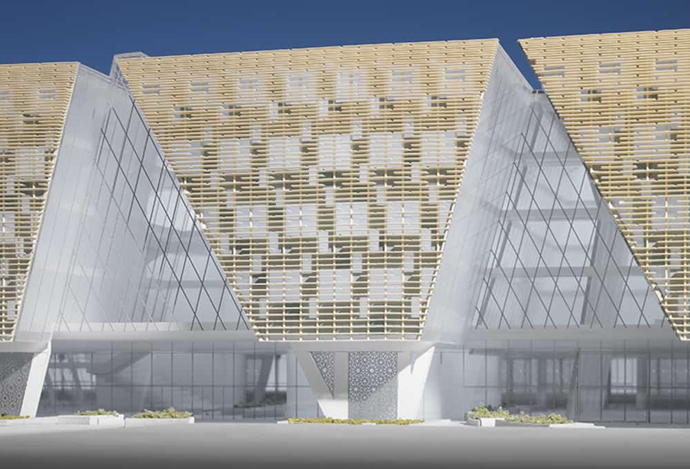 A modern building with a distinctive angular design features large glass windows and a grid-like facade, partially covered with wooden slats. The structure, reminiscent of cutting-edge 3D scanning technology, rests on white columns.