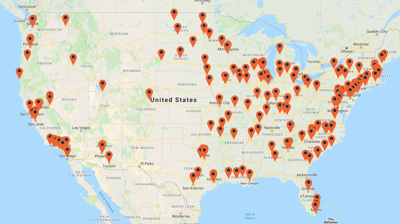 A map of the United States is marked with numerous red location pins, indicating various places across the country, showcasing locations ideal for web to print services.