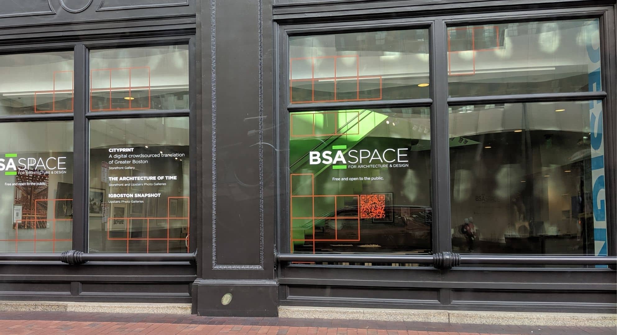 Exterior view of BSA Space with signage on the windows promoting exhibits such as 