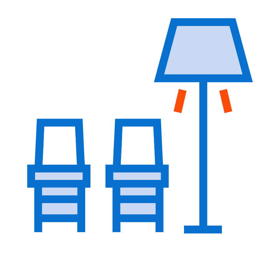 Two blue chairs are placed side by side next to a standing lamp with a blue shade and two red accents, perfect for lounging while you explore web to print services.