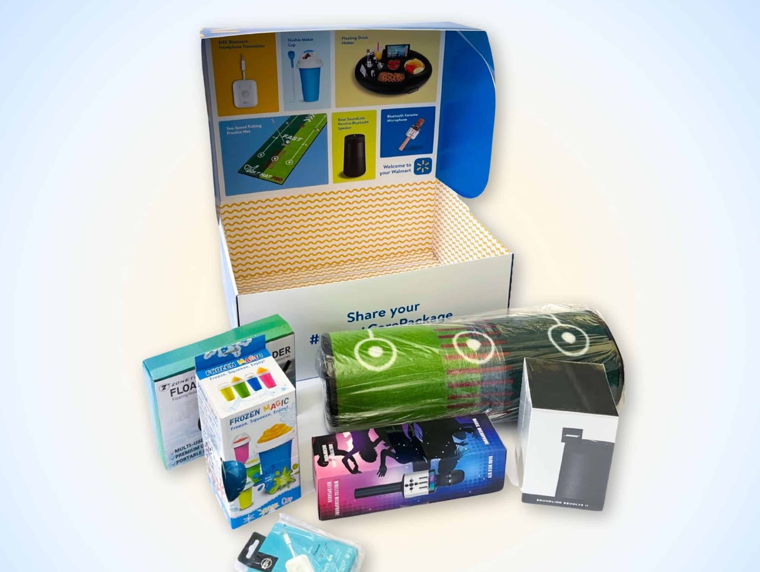 A photo showing an open box labeled "Share your #DarePackage" with various gadgets and promotional items placed in front of it, including a USB charger, floating mug, and other electronic accessories, featuring items created using 3D printing technology.