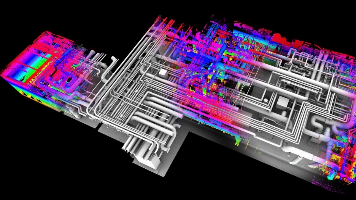 A 3D digital rendering of a complex, multicolored industrial piping system against a black background. The pipes are arranged in a dense, intricate network, showcasing the precision achievable with 3D printing technology.