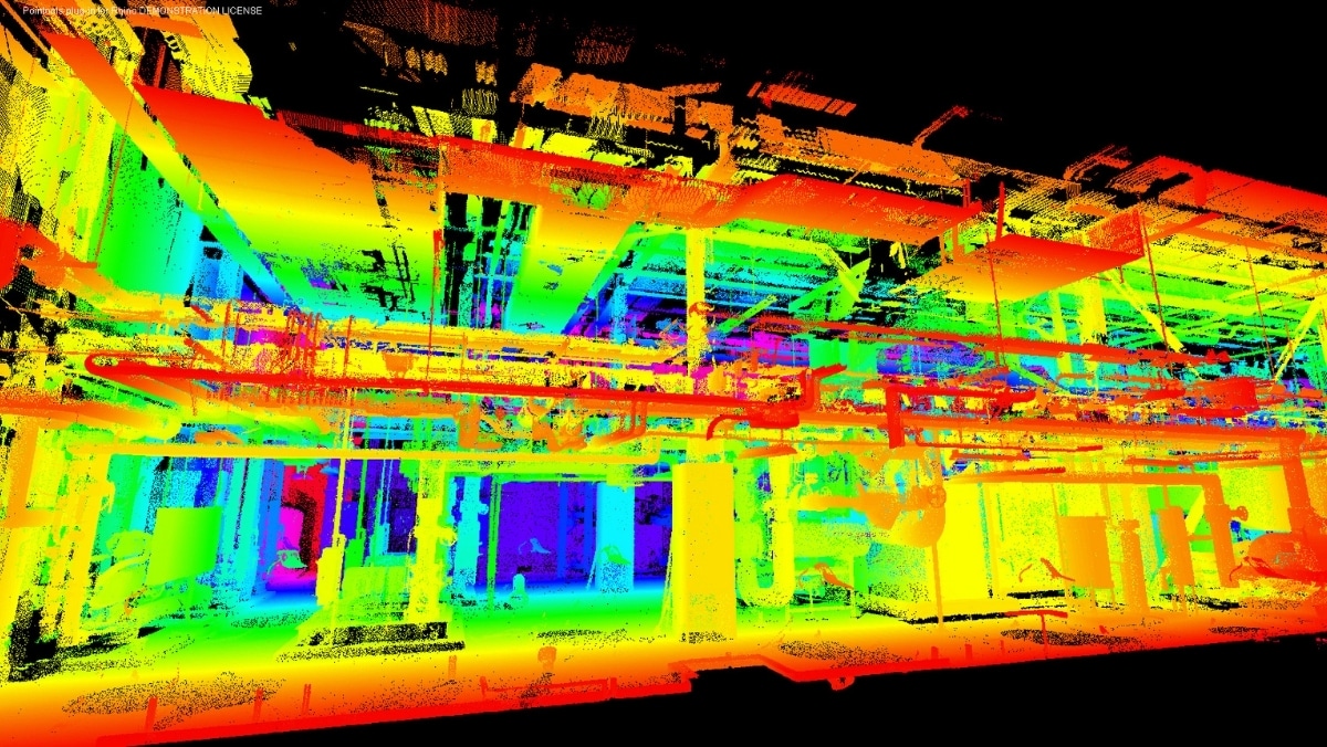 A colorful 3D point cloud scan of an industrial facility's interior, showcasing various structural and mechanical elements, seamlessly integrates with large format printing for detailed and expansive visual representations.