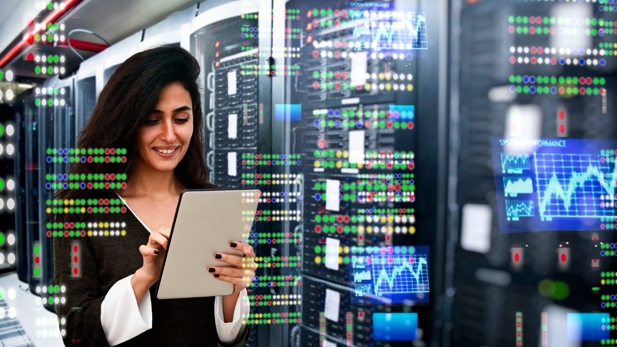 A person using a tablet stands in a server room with data analytics and various charts displayed on transparent screens, seamlessly integrating web to print technology in the foreground.