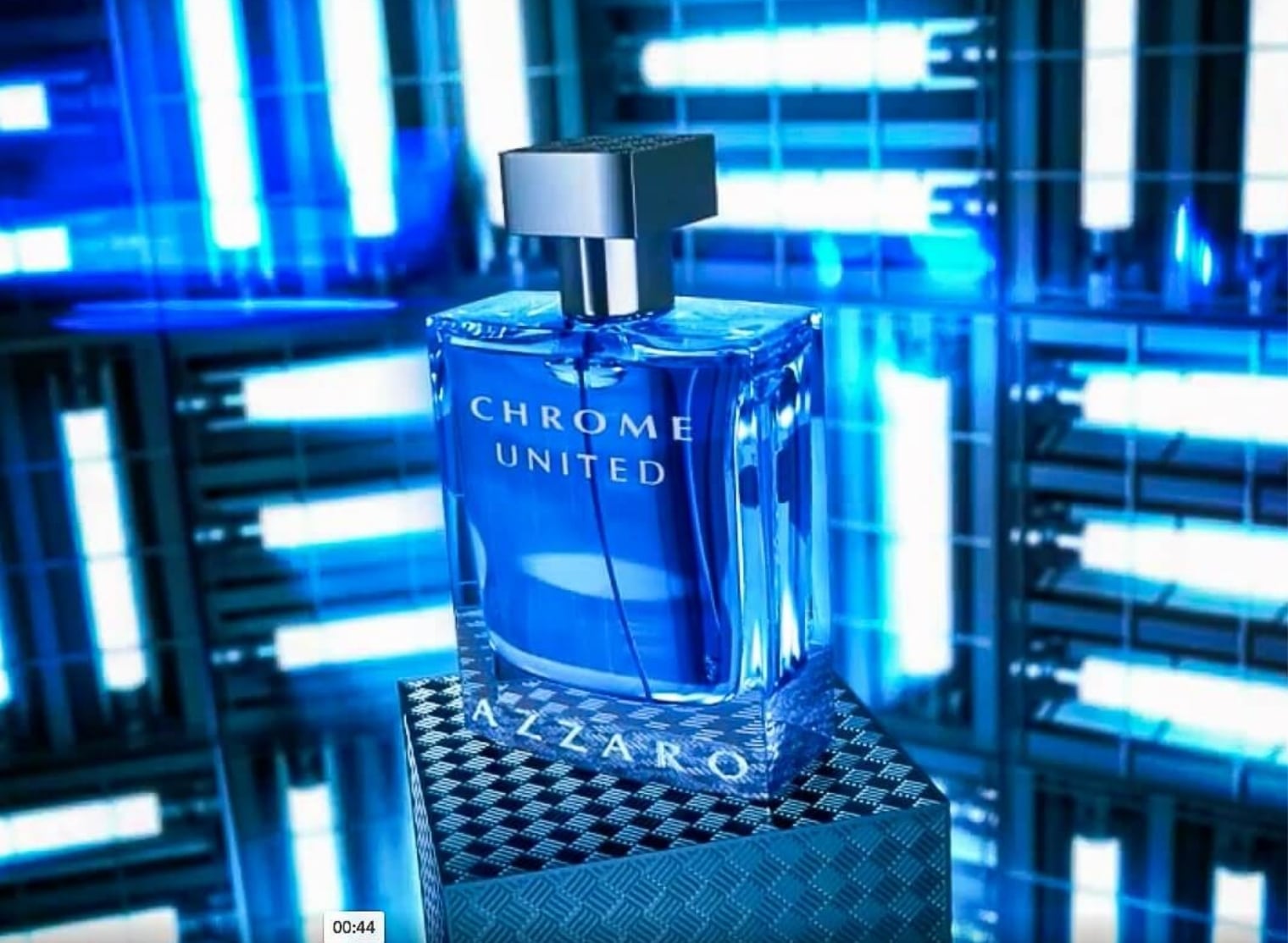 A blue bottle of Chrome United Azzaro perfume stands on a textured platform, captured with 3D scanning technology, against a blue, futuristic, glowing background.