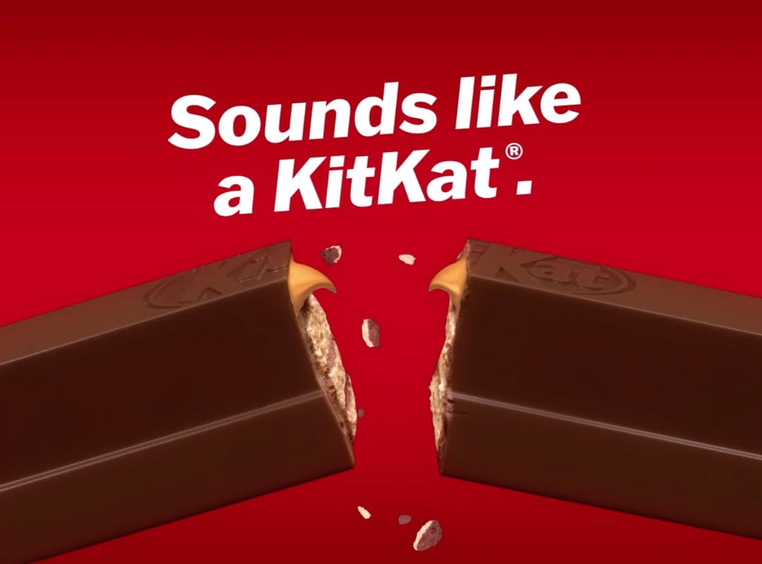 A KitKat bar broken in half, with the slogan "Sounds like a KitKat" above on a red background, captured perfectly through large format printing.