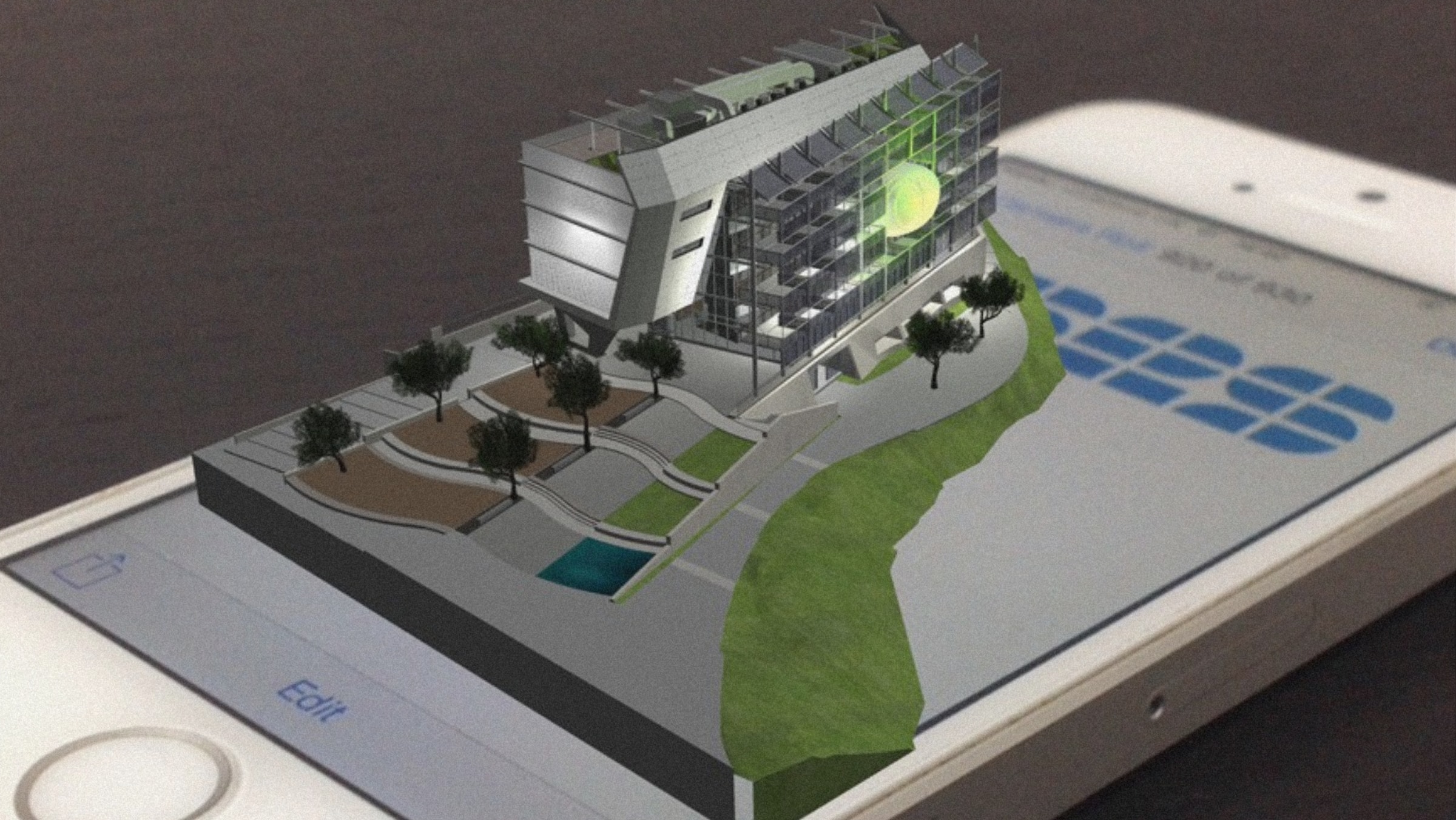 Augmented reality model of a modern building projected onto a smartphone screen, featuring detailed virtual landscaping and architectural design elements enhanced by cutting-edge 3D scanning services.